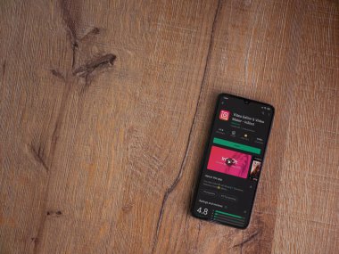 Lod, Israel - 8 Temmuz 2020: Inshot - Video Editörü ve Film Yapımcısı uygulama oyun sayfası ahşap arka planda siyah bir cep telefonunun ekranında. Üst görünüm düzlüğü kopyalama alanı ile yatıyordu.