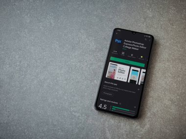 Lod, Israel - 8 Temmuz 2020: Adobe Photoshop Express Fotoğraf Editörü uygulama oyun sayfası seramik taş zemin üzerinde siyah bir cep telefonu görüntüsü. Üst görünüm düzlüğü kopyalama alanı ile yatıyordu.