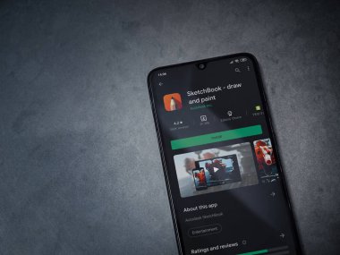 Lod, Israel - 8 Temmuz 2020: Autodesk SketchBook - koyu mermer taşlı arka planda siyah bir cep telefonunun ekranına uygulama oyun mağazası sayfası çiz ve boya. Üst görünüm düzlüğü kopyalama alanı ile yatıyordu.