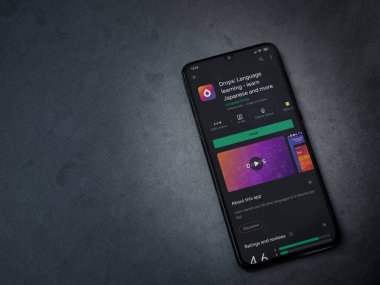 Lod, Israel - 8 Temmuz 2020: Drops - Dil öğrenme uygulaması oyun mağazası sayfası koyu mermer taştan bir arka planda siyah bir cep telefonu ekranında. Üst görünüm düzlüğü kopyalama alanı ile yatıyordu.