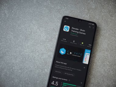Lod, Israel - 8 Temmuz 2020: Seramik taştan arka planda siyah bir cep telefonunun sergilendiği Beyin Eğitim Oyunları uygulamaları oyun mağazası sayfası. Üst görünüm düzlüğü kopyalama alanı ile yatıyordu.