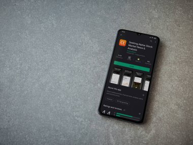 Lod, Israel - 8 Temmuz 2020: Seramik taş zemin üzerinde siyah bir cep telefonu ekranında Alfa uygulaması oyun mağazası sayfası aranıyor. Üst görünüm düzlüğü kopyalama alanı ile yatıyordu.
