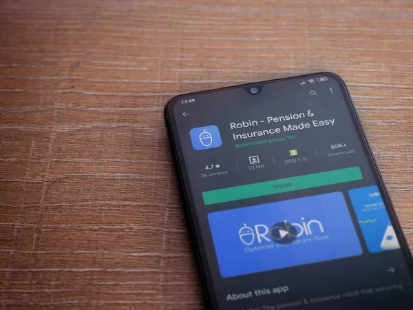 Lod, Israel - 8 Temmuz 2020: Robin uygulama oyun mağazası sayfası ahşap arka planda siyah bir cep telefonunun ekranında. Üst görünüm düzlüğü kopyalama alanı ile yatıyordu.