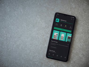 Lod, Israel - 8 Temmuz 2020: Partner Uygulama Oyun Mağazası sayfam seramik taştan arka planda siyah bir cep telefonu ekranında. Üst görünüm düzlüğü kopyalama alanı ile yatıyordu.