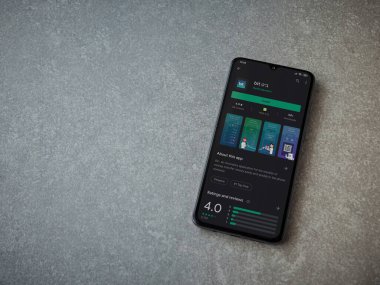 Lod, Israel - 8 Temmuz 2020: Seramik taş zemin üzerinde siyah bir cep telefonunun sergilendiği bit app oyun mağazası sayfası. Üst görünüm düzlüğü kopyalama alanı ile yatıyordu.