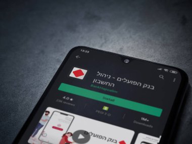 Lod, Israel - 8 Temmuz 2020: Hapoalim Bankası uygulama oyun mağazası sayfası koyu mermer taşlı arka planda siyah bir cep telefonu ekranında. Üst görünüm düzlüğü kopyalama alanı ile yatıyordu.