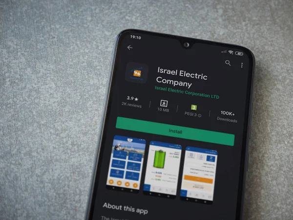 Lod, Israel - 8 Temmuz 2020: Israel Electric Corporation uygulama oyun mağazası sayfası seramik taş zemin üzerinde siyah bir cep telefonu görüntüsü. Üst görünüm düzlüğü kopyalama alanı ile yatıyordu.