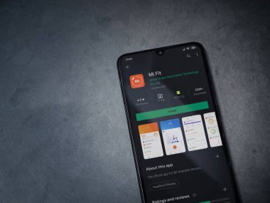 Lod, Israel - 8 Temmuz 2020: Mi Fit uygulaması oyun mağazası sayfası koyu mermer taştan arka planda siyah bir cep telefonu ekranında. Üst görünüm düzlüğü kopyalama alanı ile yatıyordu.