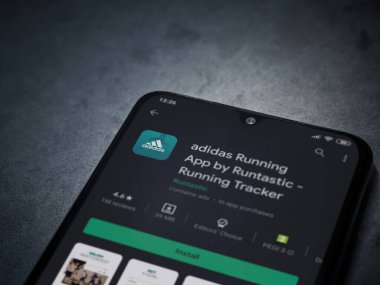 Lod, Israel - 8 Temmuz 2020: Adidas Running app playshop sayfası koyu mermer taşlı arka planda siyah bir cep telefonunun ekranında. Üst görünüm düzlüğü kopyalama alanı ile yatıyordu.
