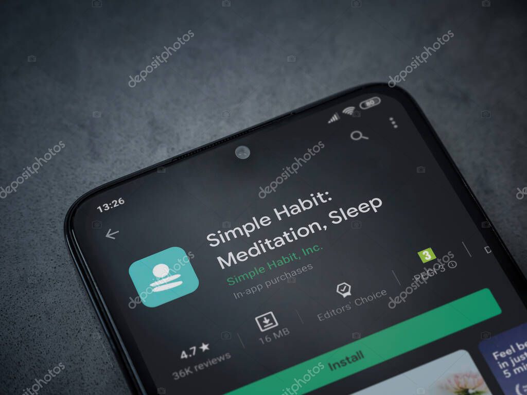 Lod, Israel - July 8, 2020: Simple Habit app play store page on the display of a black mobile smartphone on dark marble stone background. Top view flat lay with copy space.