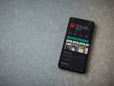 Lod, Israel - 8 Temmuz 2020: Seramik taş zemin üzerinde siyah bir cep telefonunun sergilendiği Flipboard uygulaması oyun mağazası sayfası. Üst görünüm düzlüğü kopyalama alanı ile yatıyordu.