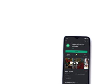 Lod, Israel - 8 Temmuz 2020: Fiverr uygulama oyun mağazası sayfası beyaz arkaplanda izole edilmiş siyah bir cep telefonu ekranında. Üst görünüm düzlüğü kopyalama alanı ile yatıyordu.