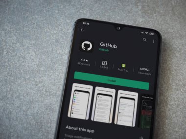 Lod, Israel - 8 Temmuz 2020: GitHub uygulaması oyun mağazası sayfası seramik taş zemin üzerinde siyah bir cep telefonu görüntüsü. Üst görünüm düzlüğü kopyalama alanı ile yatıyordu.