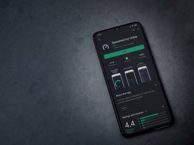 Lod, Israel - 8 Temmuz 2020: Koyu mermer taştan arka planda siyah bir cep telefonunun ekranında en hızlı uygulama oyun mağazası sayfası. Üst görünüm düzlüğü kopyalama alanı ile yatıyordu.