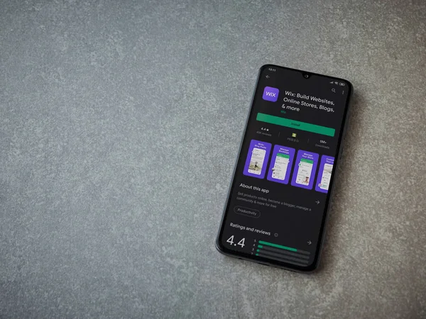 Lod, Israel - 8 Temmuz 2020: Wix uygulaması oyun mağazası sayfası seramik taş zemin üzerinde siyah bir cep telefonu görüntüsü. Üst görünüm düzlüğü kopyalama alanı ile yatıyordu.