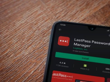 Lod, Israel - 8 Temmuz 2020: LastPass Şifre Yöneticisi uygulama oyun mağazası sayfası ahşap arka planda siyah bir cep telefonu sergilenmektedir. Üst görünüm düzlüğü kopyalama alanı ile yatıyordu.