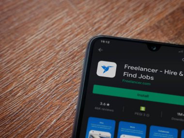 Lod, Israel - 8 Temmuz 2020: Freelancer uygulama oyun mağazası sayfası ahşap arka planda siyah bir cep telefonunun ekranında. Üst görünüm düzlüğü kopyalama alanı ile yatıyordu.