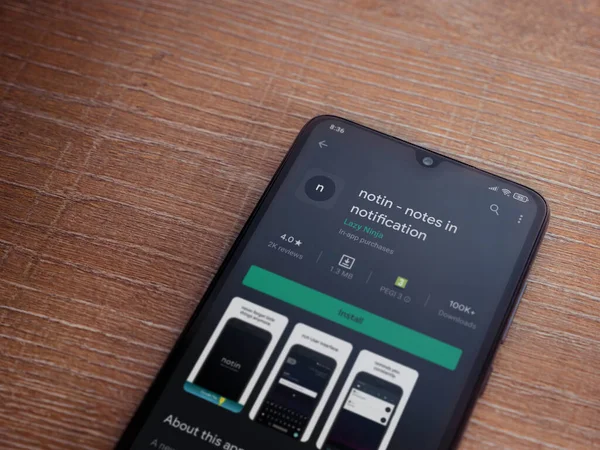 Lod, Israel - 8 Temmuz 2020: Uygulama oyun mağazası sayfasında ahşap arka planda siyah bir cep telefonu görüntüsü yok. Üst görünüm düzlüğü kopyalama alanı ile yatıyordu.