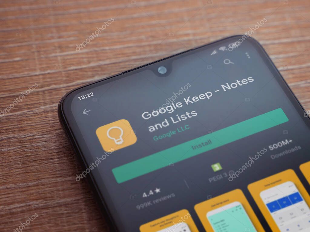 Lod, Israel - July 8, 2020: Google Keep app play store page on the display of a black mobile smartphone on wooden background. Top view flat lay with copy space.