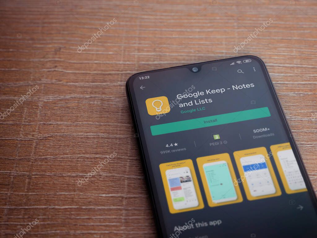 Lod, Israel - July 8, 2020: Google Keep app play store page on the display of a black mobile smartphone on wooden background. Top view flat lay with copy space.