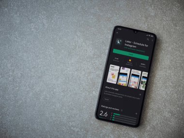 Lod, Israel - 8 Temmuz 2020: Daha sonra uygulamalı oyun mağazası sayfası seramik taş zemin üzerinde siyah bir cep telefonu görüntüsü. Üst görünüm düzlüğü kopyalama alanı ile yatıyordu.