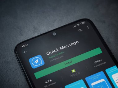 Lod, Israel - 8 Temmuz 2020: Hızlı Mesaj uygulaması oyun mağazası sayfası koyu mermer taşlı arka planda siyah bir cep telefonu ekranında. Üst görünüm düzlüğü kopyalama alanı ile yatıyordu.