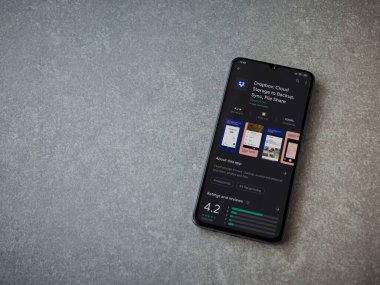 Lod, Israel - 8 Temmuz 2020: Seramik taş zemin üzerinde siyah bir cep telefonu ekranında Dropbox uygulaması oyun mağazası sayfası. Üst görünüm düzlüğü kopyalama alanı ile yatıyordu.