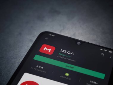 Lod, Israel - 8 Temmuz 2020: MeGA uygulama oyun mağazası sayfası koyu mermer taştan arka planda siyah bir cep telefonu ekranında. Üst görünüm düzlüğü kopyalama alanı ile yatıyordu.