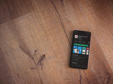 Lod, Israel - 8 Temmuz 2020: Cep telefonu uygulaması oyun mağazası sayfası ahşap arka planda siyah bir cep telefonu ekranında. Üst görünüm düzlüğü kopyalama alanı ile yatıyordu.