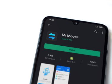 Lod, Israel - 8 Temmuz 2020: Mi Mover uygulaması oyun mağazası sayfası beyaz arkaplanda izole edilmiş siyah bir cep telefonu ekranında. Üst görünüm düzlüğü kopyalama alanı ile yatıyordu.