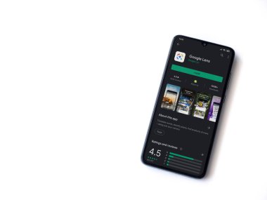 Lod, Israel - 8 Temmuz 2020: Google Lens uygulaması oyun mağazası sayfası beyaz arkaplanda izole edilmiş siyah bir cep telefonu ekranında. Üst görünüm düzlüğü kopyalama alanı ile yatıyordu.