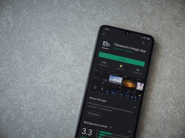 Lod, Israel - 8 Temmuz 2020: Panasonic Image App uygulama oyun mağazası sayfası seramik taş zemin üzerinde siyah bir cep telefonu görüntüsü. Üst görünüm düzlüğü kopyalama alanı ile yatıyordu.