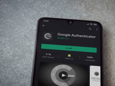 Lod, Israel - 8 Temmuz 2020: Google Authenticator uygulama oyun mağazası sayfası seramik taş zemin üzerinde siyah bir cep telefonu görüntüsü. Üst görünüm düzlüğü kopyalama alanı ile yatıyordu.