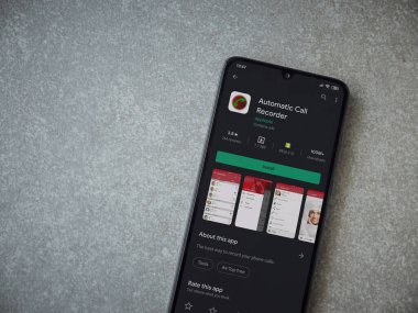 Lod, Israel - 8 Temmuz 2020: Seramik taş zemin üzerinde siyah bir cep telefonunun ekranında otomatik arama kaydedici uygulama oyun mağazası sayfası. Üst görünüm düzlüğü kopyalama alanı ile yatıyordu.