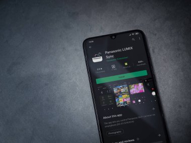 Lod, Israel - 8 Temmuz 2020: Panasonic LUMIX Sync uygulama oyun mağazası sayfası koyu mermer taştan arka planda siyah bir cep telefonu görüntüsü. Üst görünüm düzlüğü kopyalama alanı ile yatıyordu.