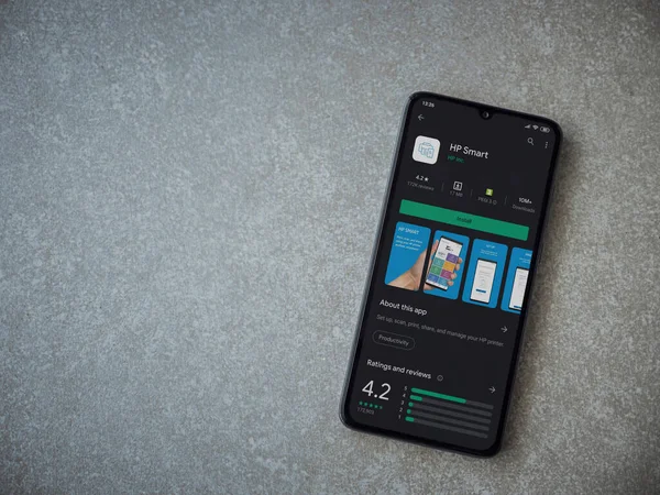 Lod, Israel - 8 Temmuz 2020: HP Smart uygulama oyun mağazası sayfası seramik taş zemin üzerinde siyah bir cep telefonu görüntüsü. Üst görünüm düzlüğü kopyalama alanı ile yatıyordu.