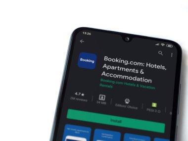 Lod, Israel - 8 Temmuz 2020: Booking.com uygulama oyun mağazası sayfası beyaz arkaplanda izole edilmiş siyah bir cep telefonu ekranında. Üst görünüm düzlüğü kopyalama alanı ile yatıyordu.