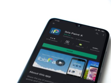 Lod, Israel - 8 Temmuz 2020: Ibis Paint X uygulama oyun mağazası sayfası beyaz arkaplanda izole edilmiş siyah bir cep telefonu ekranında. Üst görünüm düzlüğü kopyalama alanı ile yatıyordu.