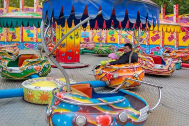 baba ve kızı lunaparkta atlıkarınca üzerinde dönen