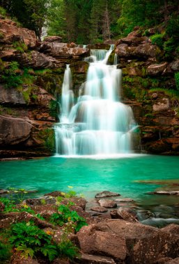 Rivers and waterfalls of the Ordesa y Monte Perdido National Park. The water runs freely through this national park. Aragon.Spain clipart