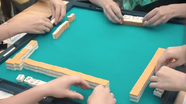 People playing mahjong asian tile-based game. Table gambling — Stock Video