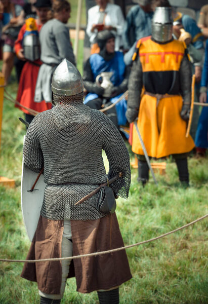 RITTER WEG, MOROZOVO, APRIL 2017: Festival of the European Middle Ages. Medieval joust knights in helmets and chain mail battle on swords with shields in their hands