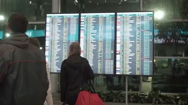Mosca, Russia - 6 maggio 2019: La gente aspetta la partenza in aeroporto, imbarco di partenza, visualizzazione elettronica degli orari aeroportuali, statica. Visualizzazione elettronica delle partenze e degli arrivi in aeroporto — Video Stock