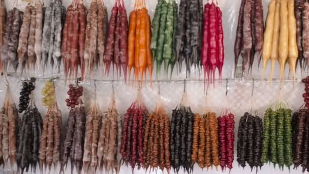 Panorama de dulce churchkhela en el mercado de agricultores bazar en Georgia. Colorida Churchkhela colgando en el escaparate del mercado — Vídeos de Stock