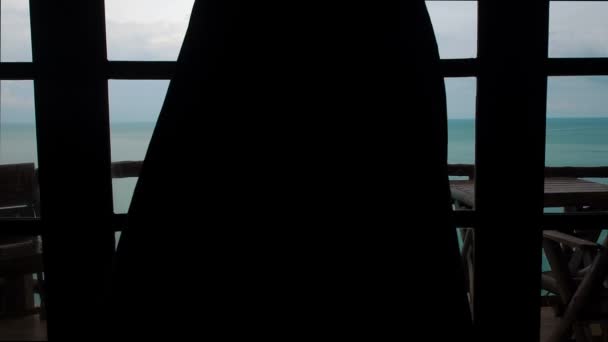 Belle fille mince sans vêtements jette d'une cape ouvre la porte et va à la terrasse vue sur la mer. Jeune femme sexy libre se tient et regarde l'horizon du paysage océanique depuis le balcon. Ralenti suite à un — Video