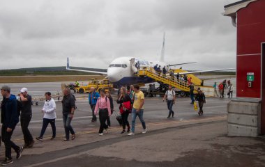 Kiruna Havaalanı, Laponya, İsveç 'te uçaklar ve gezginler. Uçaktan ayrılan yolcular.