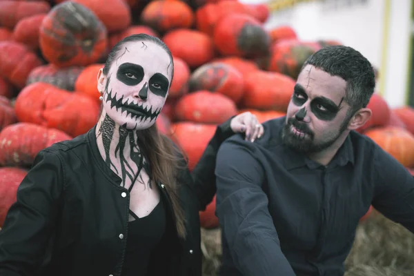 Couple with scary makeup celebrating halloween outdoor
