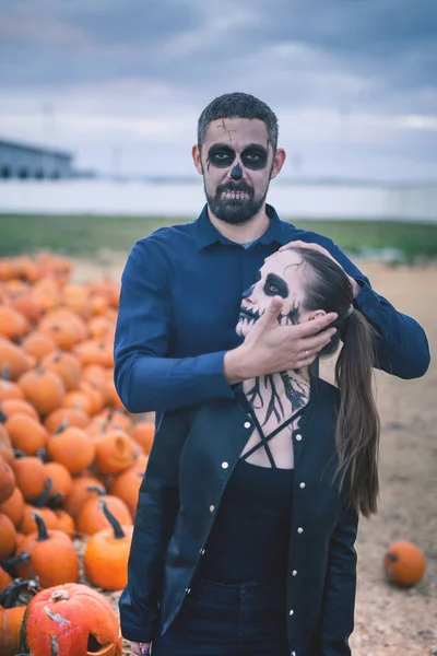 Couple with scary makeup celebrating halloween outdoor