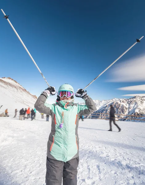 Happy child skier has fun in mountains holds ski poles. — Stock Photo, Image