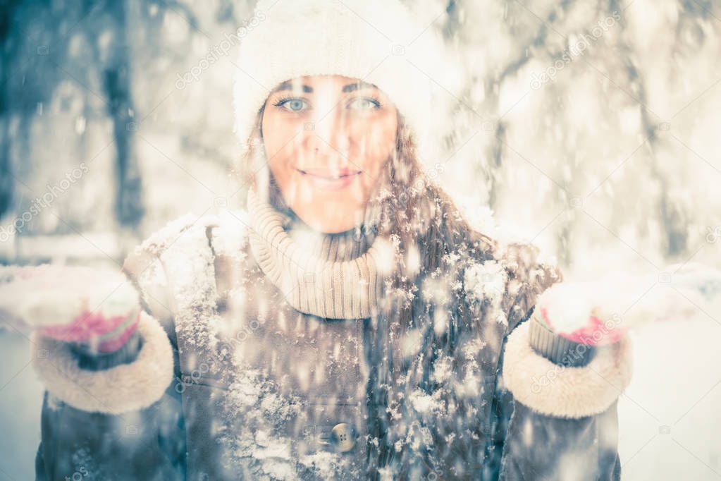 Happy woman at cold snowy winter at New York Park